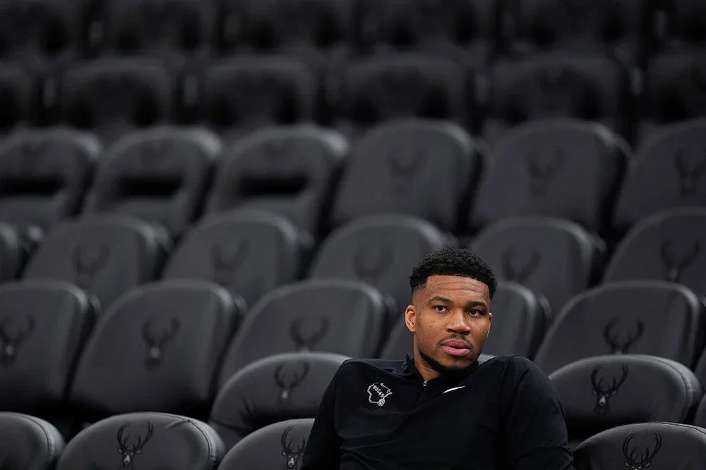 Giannis Antetokounmpo looks on from the Bucks' stands.